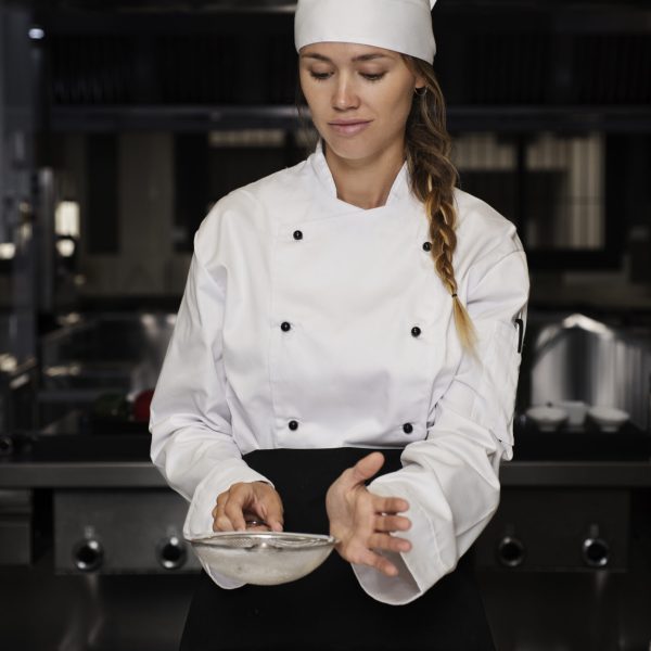 female-chef-kitchen-sieving-powdered-sugar-dessert